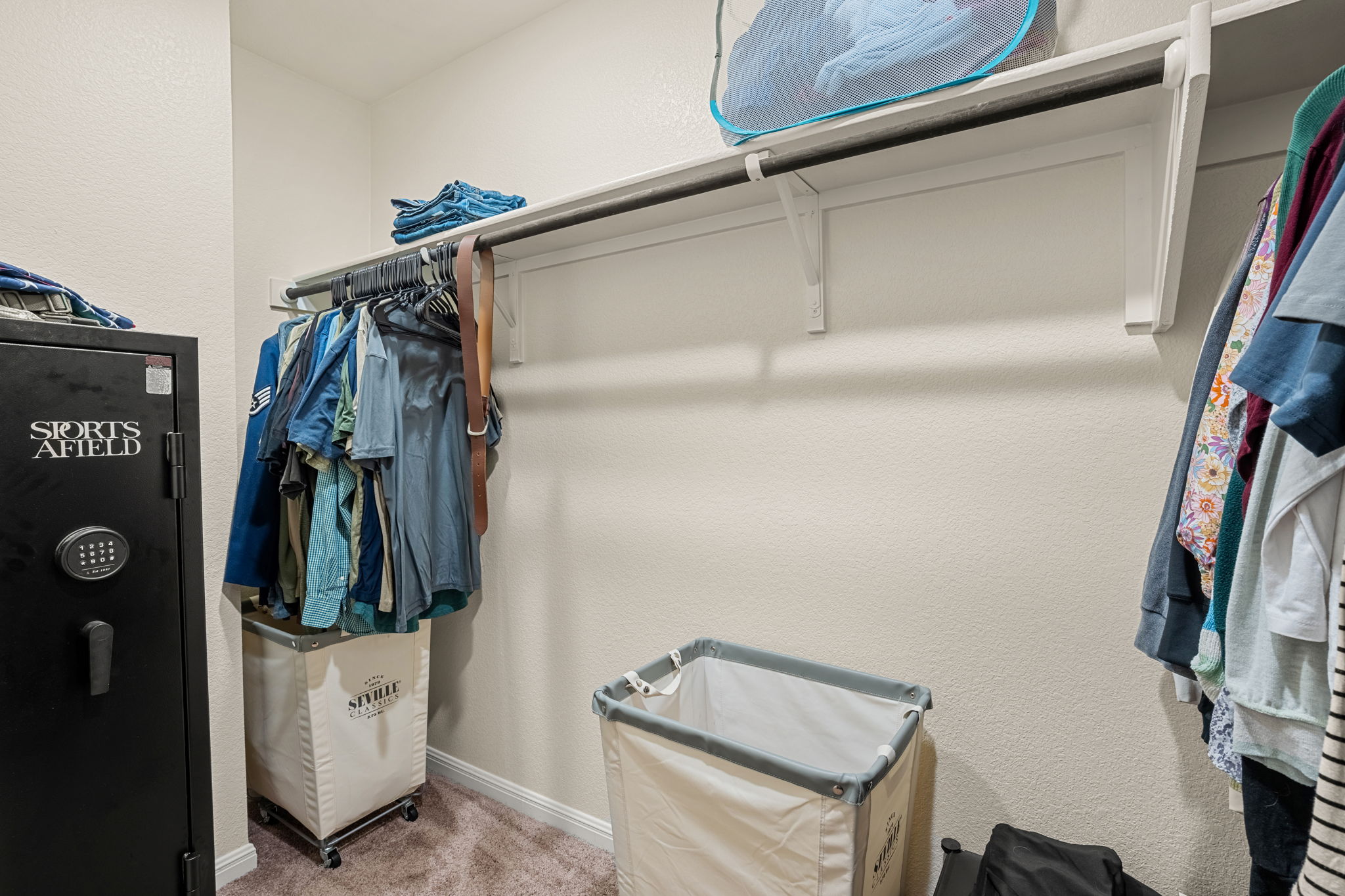 148 Hidalgo Lane Elgin, TX 78621 - Photo 24 of 38 An organized walk-in closet provides ample storage with integrated shelving and hanging rods.