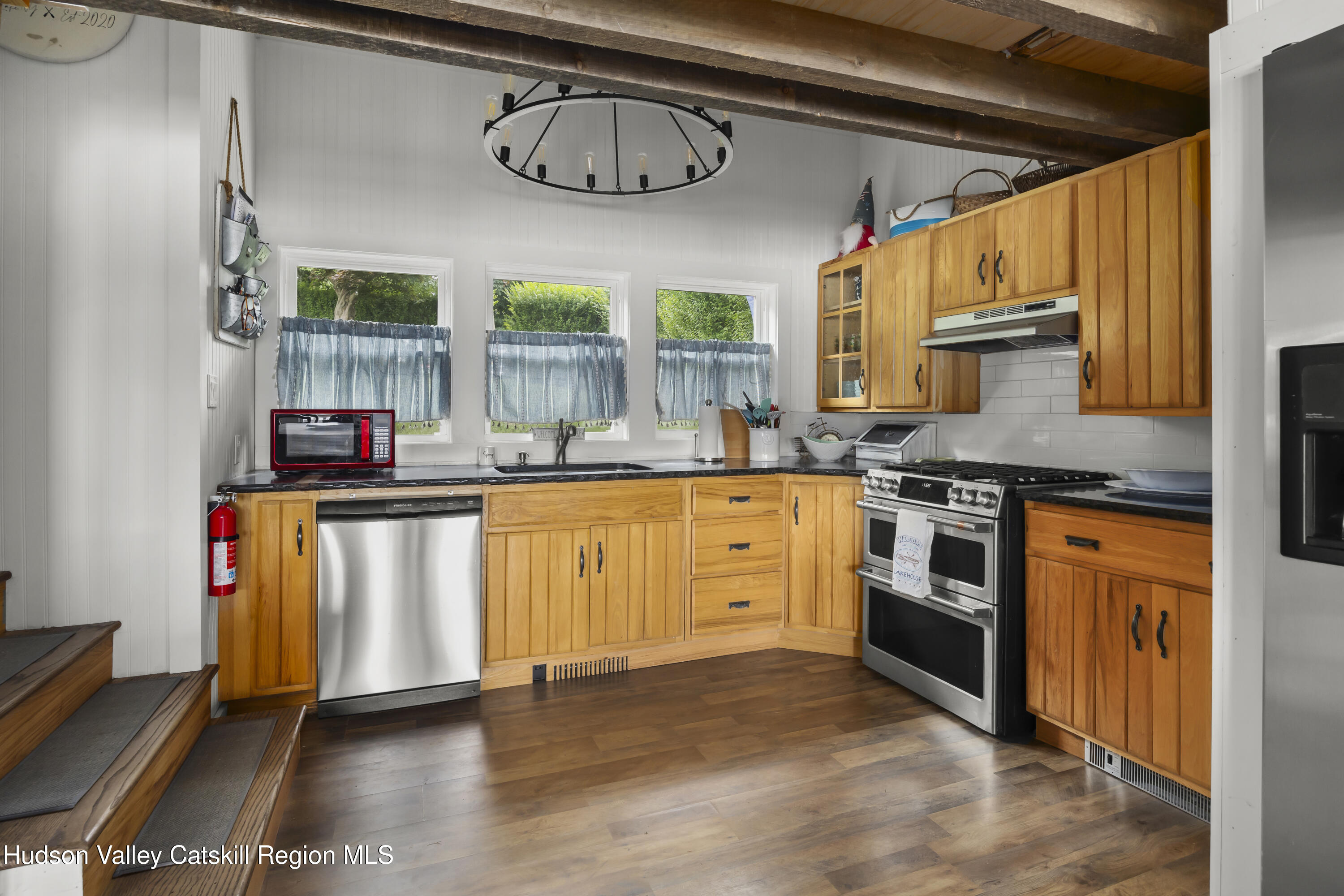 44 Southwest Colony Road Hillsdale, NY 12529 - Photo 10 of 40 a kitchen with stainless steel appliances granite countertop a stove a sink and a refrigerator