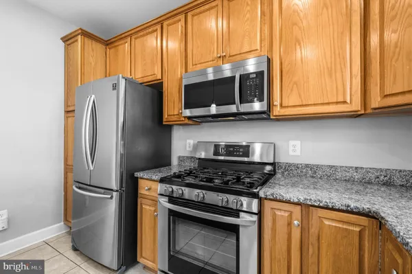 a kitchen with stainless steel appliances granite countertop a refrigerator stove and microwave
