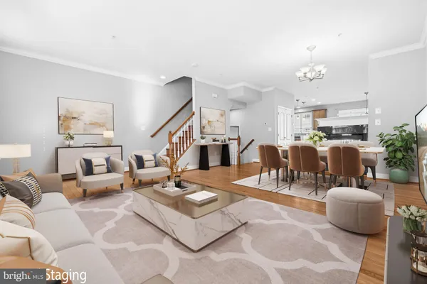 a living room with lots of furniture and kitchen view