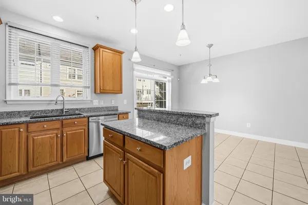 a kitchen with stainless steel appliances granite countertop a sink and a granite counter tops