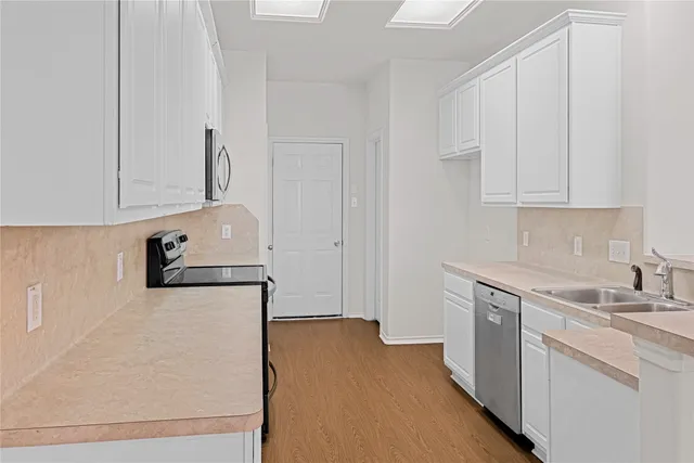 a utility room with cabinets washer and dryer