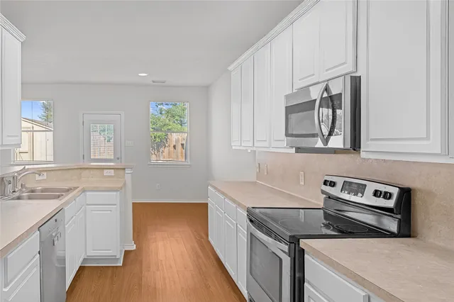 a kitchen with a stove microwave and sink