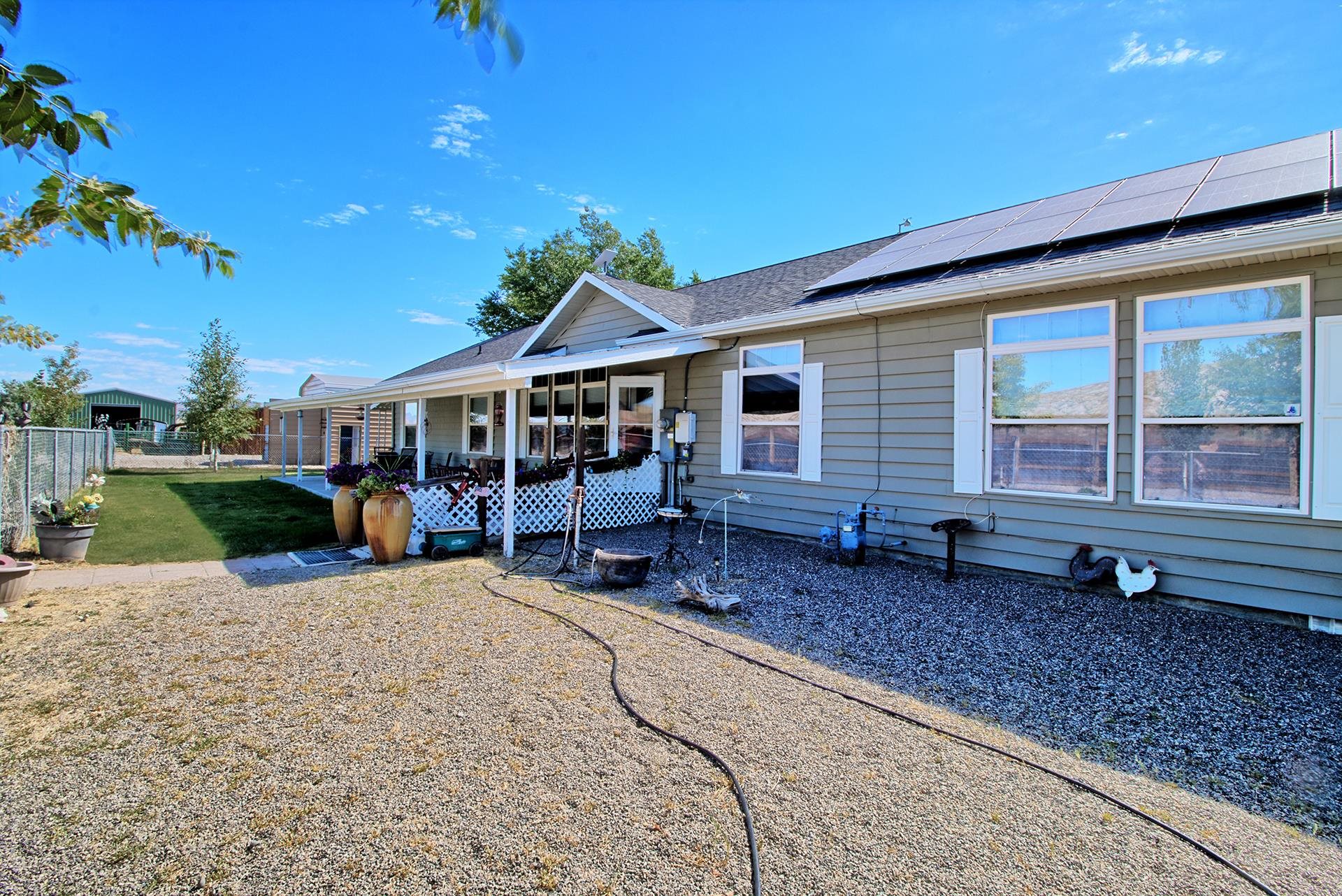 1724 O Road Fruita, CO 81521 - Photo 4 of 42 a view of a house with backyard porch and sitting area
