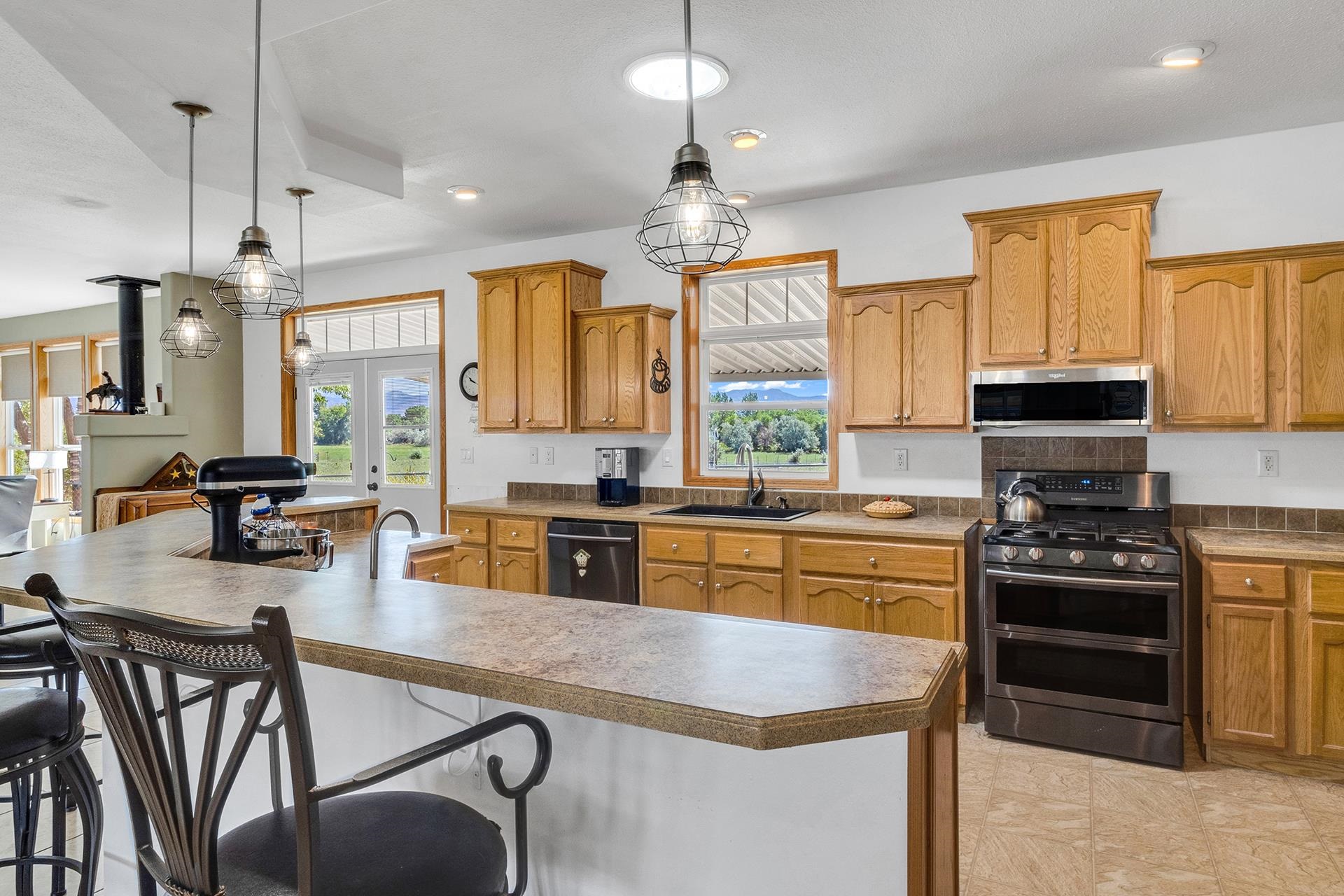 1724 O Road Fruita, CO 81521 - Photo 8 of 42 a kitchen with stainless steel appliances granite countertop wooden cabinets a stove a sink a dining table and chairs