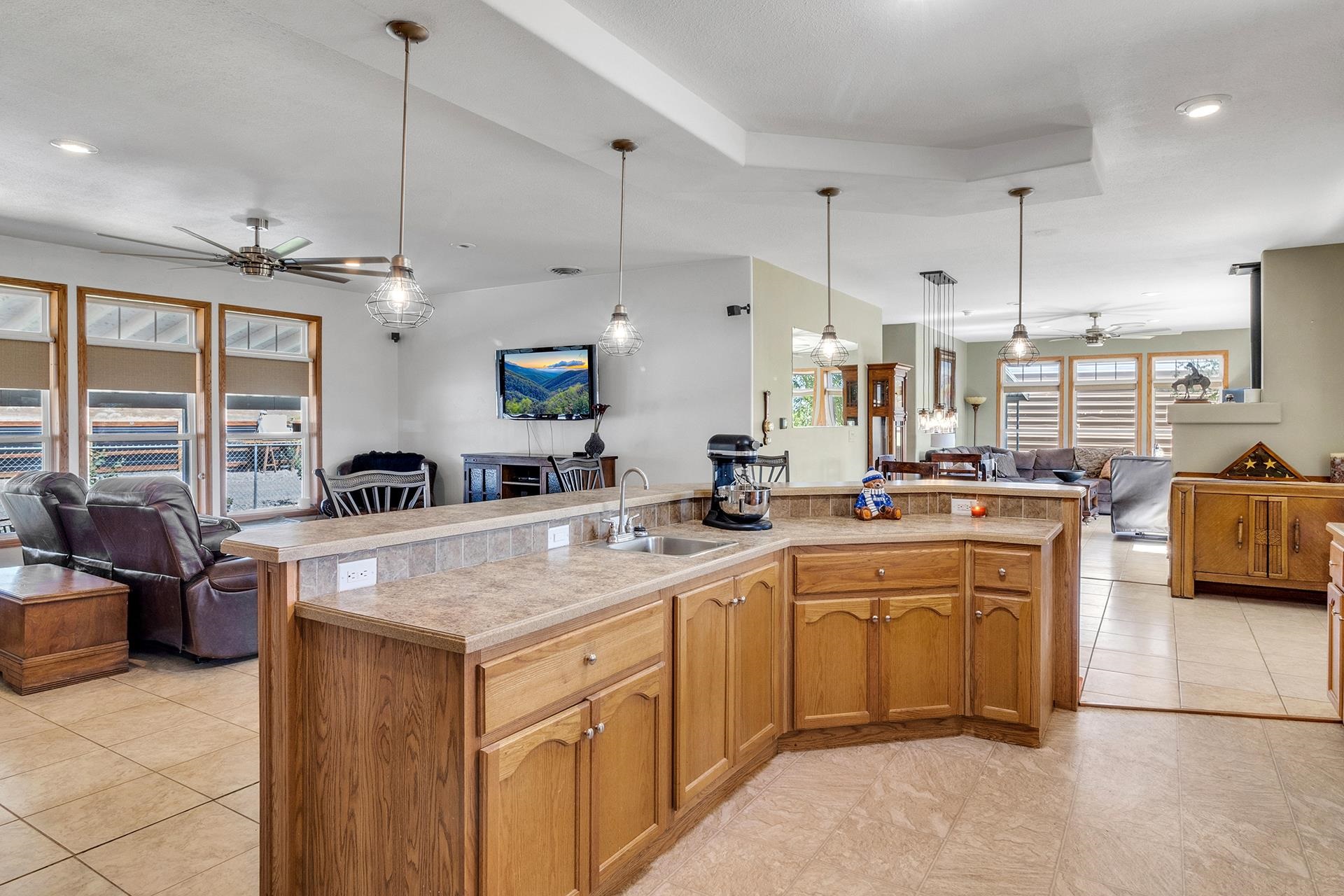 1724 O Road Fruita, CO 81521 - Photo 9 of 42 a large kitchen with kitchen island a large counter top space a sink a stove and a window