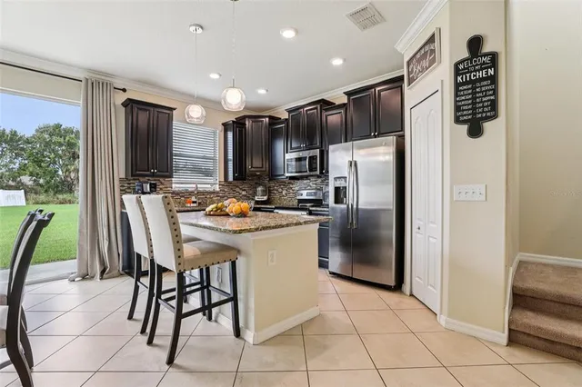 a view of a dining room with furniture a chandelier and window