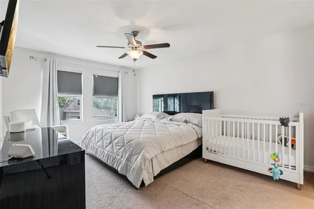 a bedroom with a bed dresser and a window