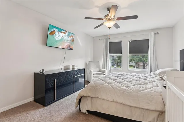 a bedroom with a bed and a desk