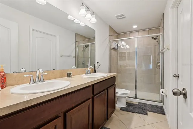 a bathroom with a sink double vanity and a mirror