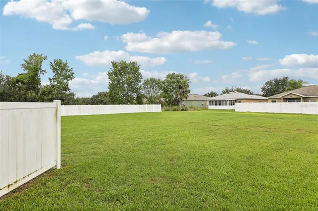 a view of yard with swimming pool and green space