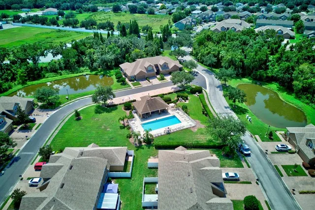 a view of house with outdoor space and swimming pool