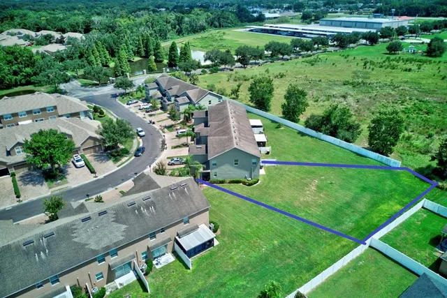 an aerial view of multiple houses with yard