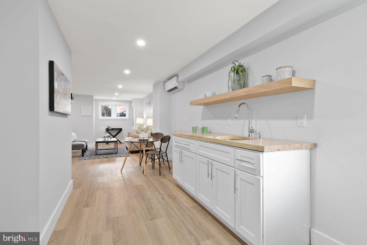1023 Florida Avenue Northeast Washington, DC 20002 - Photo 18 of 24 a kitchen with sink cabinets and dining table