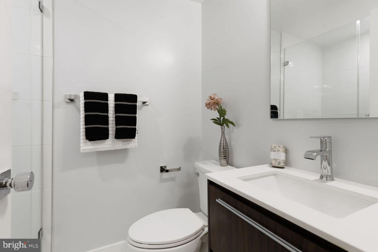 1023 Florida Avenue Northeast Washington, DC 20002 - Photo 19 of 24 a bathroom with a sink a toilet and shower