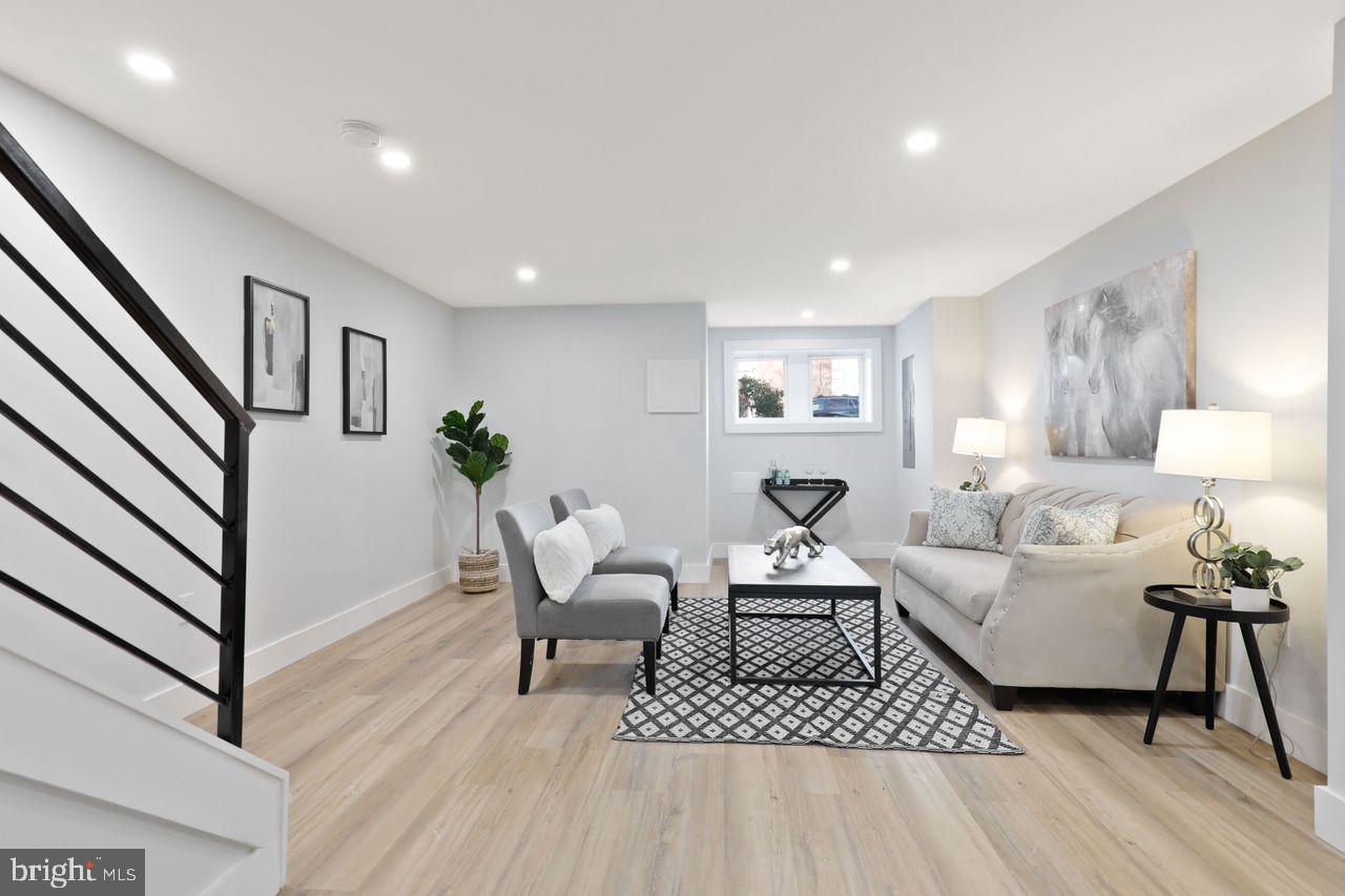 1023 Florida Avenue Northeast Washington, DC 20002 - Photo 23 of 24 a living room with furniture and a wooden floor