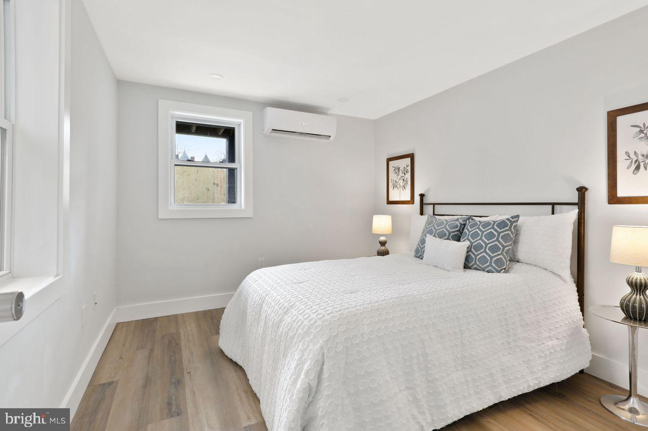 1023 Florida Avenue Northeast Washington, DC 20002 - Photo 24 of 24 a bedroom with a bed and a night stand