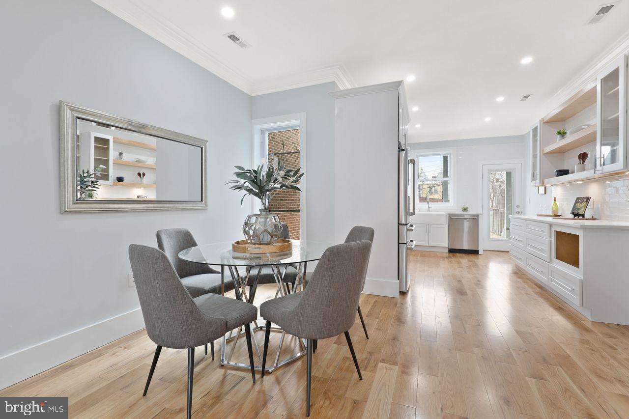 1023 Florida Avenue Northeast Washington, DC 20002 - Photo 3 of 24 a view of a dining room with furniture and wooden floor
