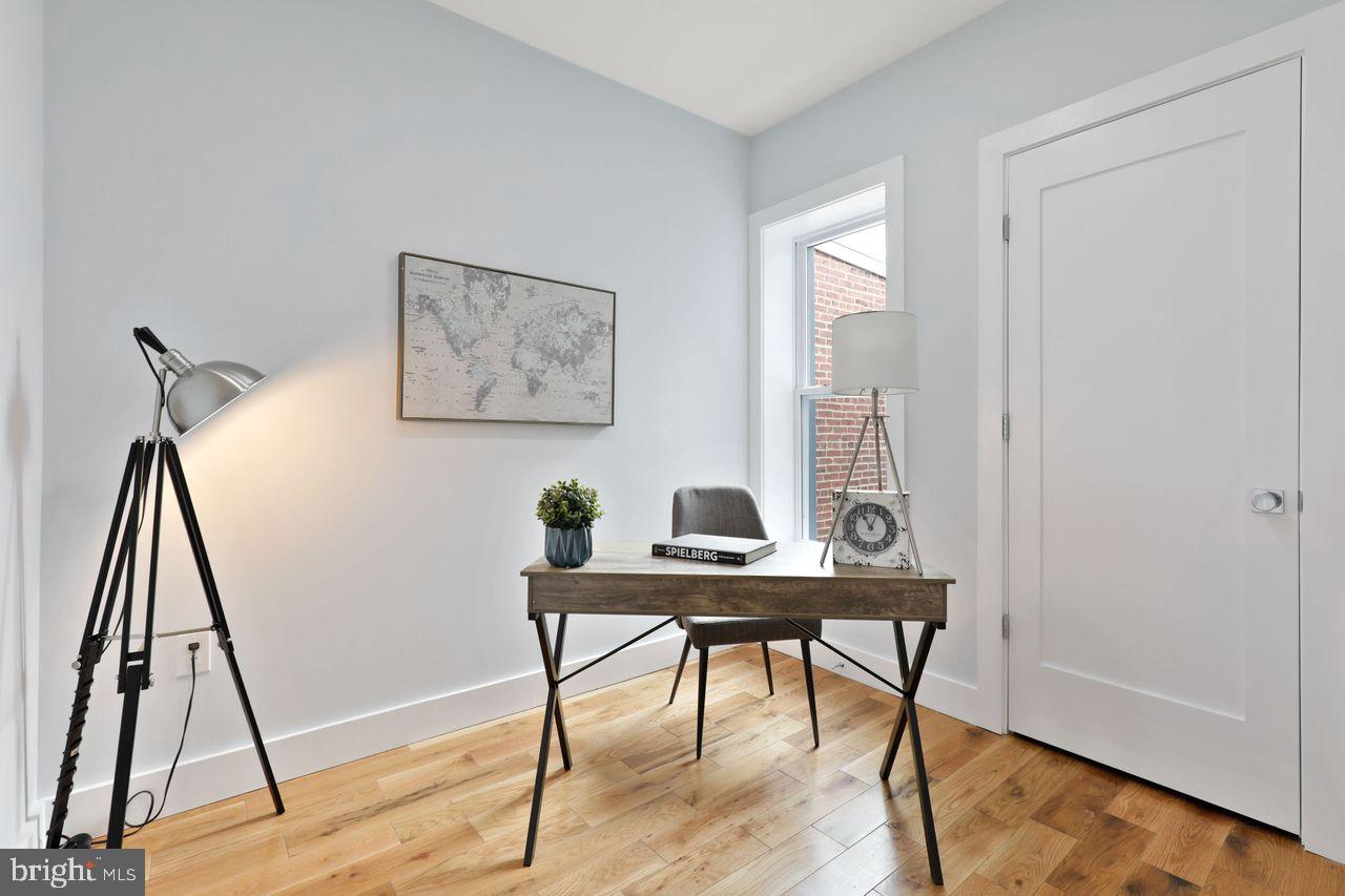 1023 Florida Avenue Northeast Washington, DC 20002 - Photo 4 of 24 a view of a workspace with furniture and wooden floor