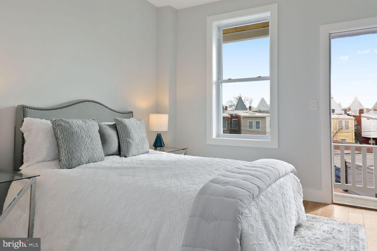1023 Florida Avenue Northeast Washington, DC 20002 - Photo 6 of 24 a bedroom with a bed and a window