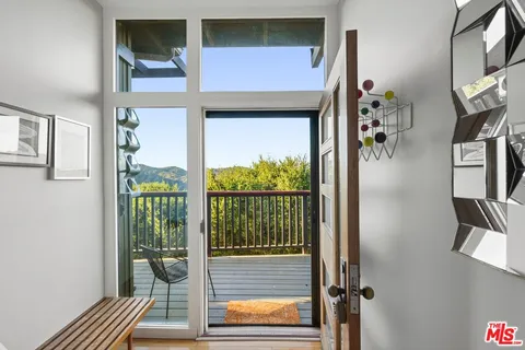 a living room with furniture and large windows