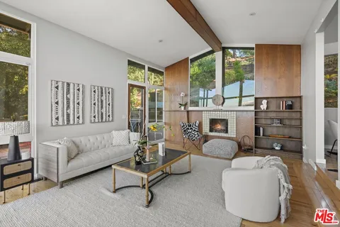 a kitchen with stainless steel appliances kitchen island granite countertop a table chairs in it and wooden floors