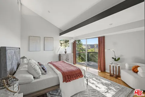 a view of a pathway of a house with large trees