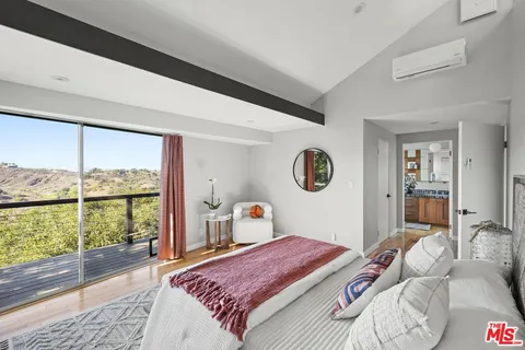 a bedroom with a bed and a mirror