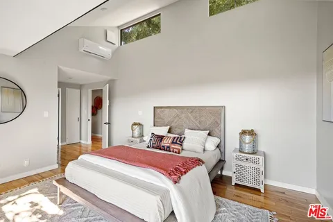 a bedroom with a bed and glass door