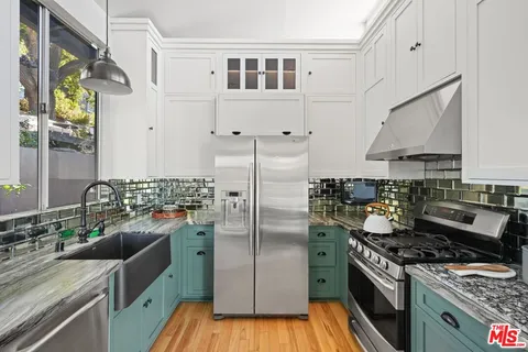 a kitchen with stainless steel appliances granite countertop a stove a sink dishwasher and refrigerator