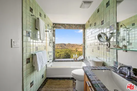 a view of a patio with couches and potted plants with sky view