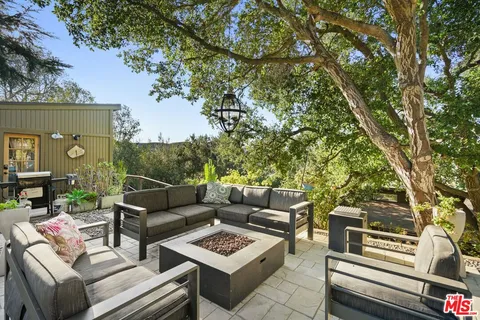 a bathroom with a granite countertop sink toilet and a window