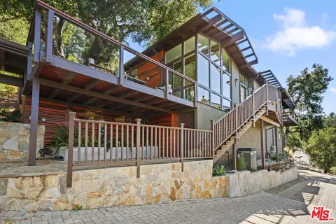 a view of a porch with a table and chairs