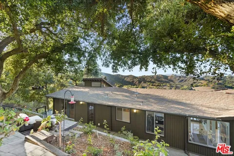 a view of balcony with wooden floor and fence
