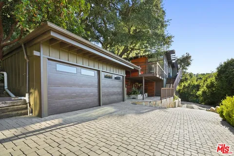 a balcony with wooden floor and fence