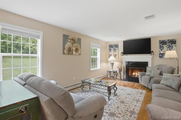 29 Hickory Hill Road Newburgh, NY 12550 - Photo 12 of 47 a living room with furniture a flat screen tv and a fireplace
