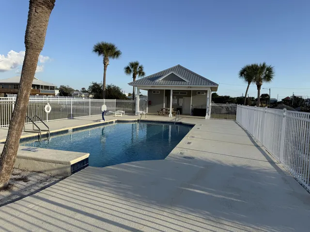 a view of swimming pool with a table and chairs