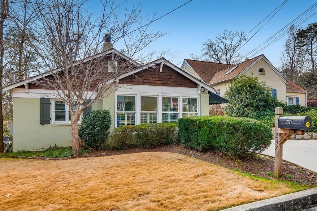 237 Springdale Drive Northeast Atlanta, GA 30305 - Photo 1 of 1 a front view of a house with garden