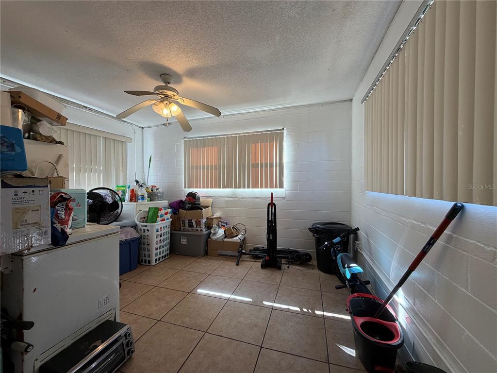 348 Pleasant Street Daytona Beach, FL 32114 - Photo 11 of 12 a room with furniture a chandelier and a window