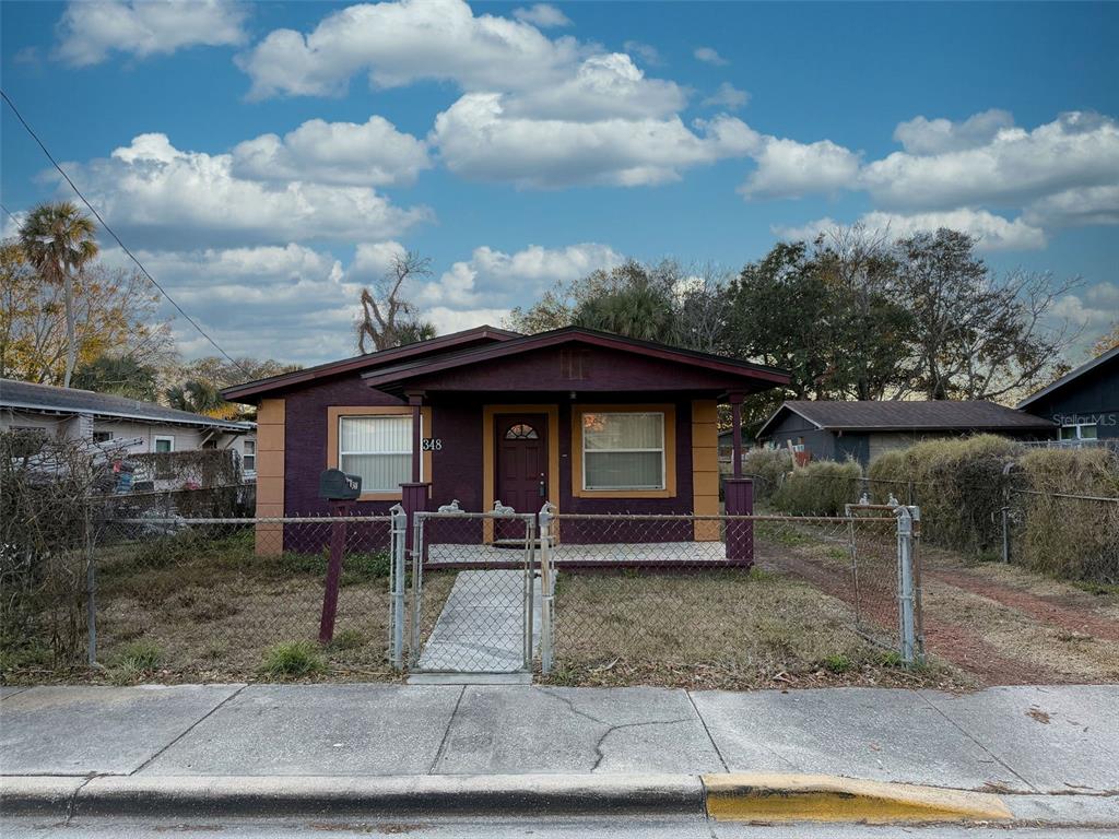 348 Pleasant Street Daytona Beach, FL 32114 - Photo 2 of 12 a front view of a house with garden