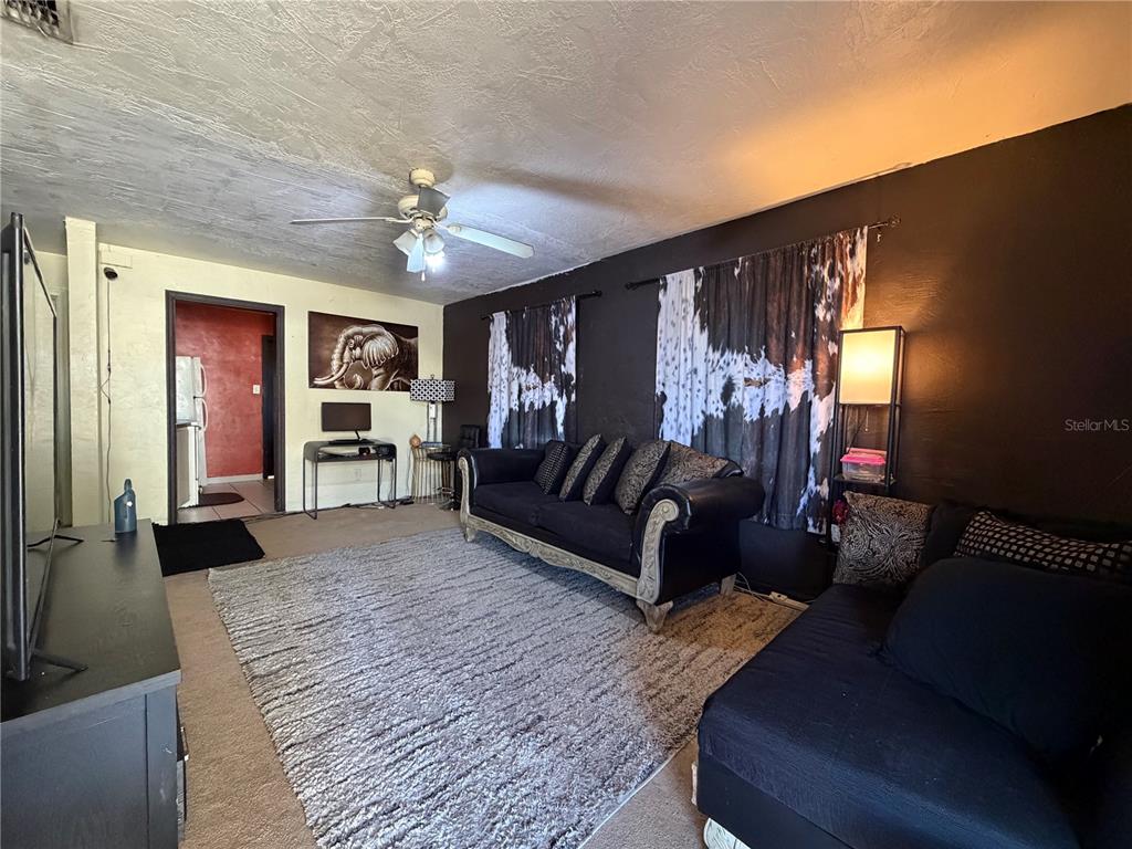 348 Pleasant Street Daytona Beach, FL 32114 - Photo 3 of 12 a living room with furniture and a chandelier