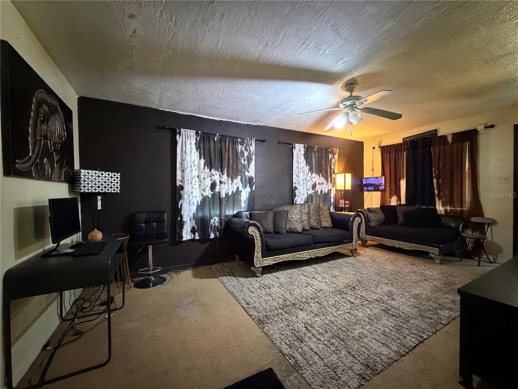 348 Pleasant Street Daytona Beach, FL 32114 - Photo 4 of 12 a living room with furniture and a fireplace