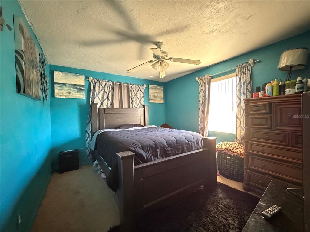 348 Pleasant Street Daytona Beach, FL 32114 - Photo 9 of 12 a bedroom with a bed and a window