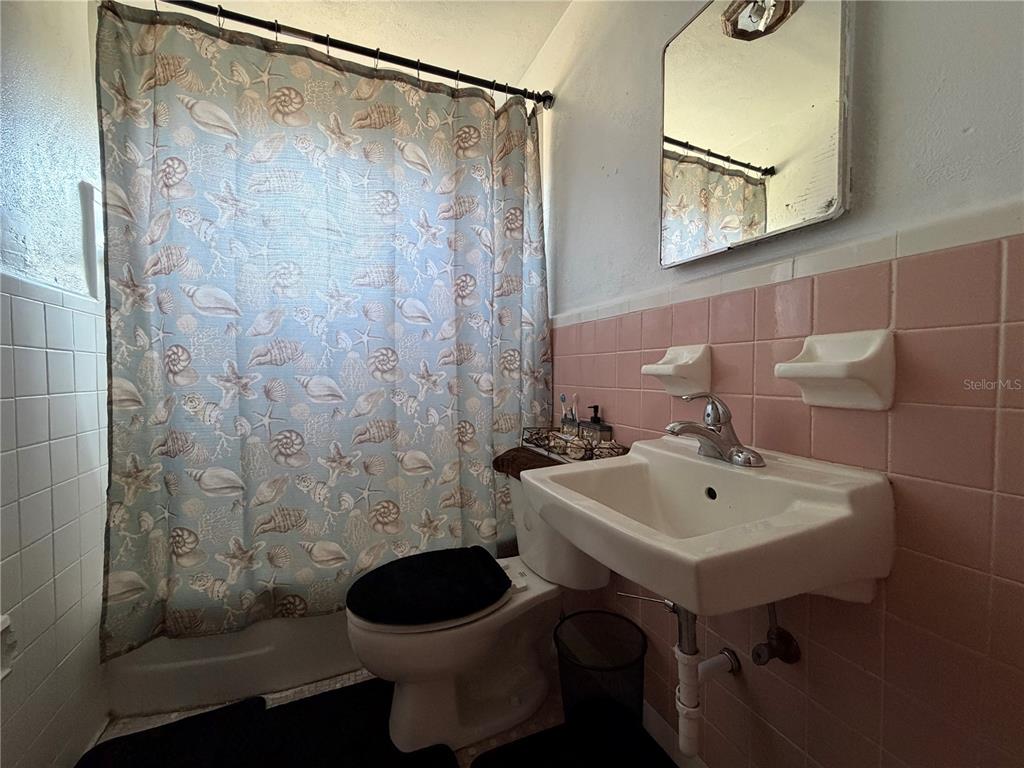 348 Pleasant Street Daytona Beach, FL 32114 - Photo 10 of 12 a bathroom with a sink a toilet and shower