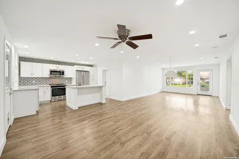 a view of a kitchen with wooden floor and a kitchen