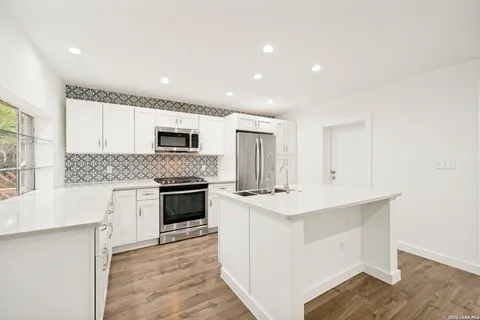 a kitchen with a stove oven and sink
