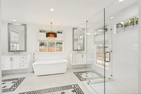 a bathroom with a tub shower and sink