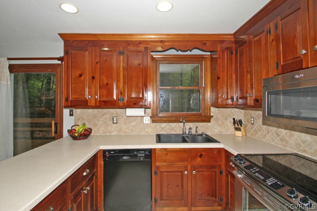 13601 Timber Ridge Court Midlothian, VA 23112 - Photo 8 of 21 a kitchen with stainless steel appliances a sink stove and cabinets