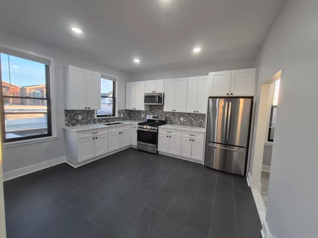 a kitchen with a white cabinets and white stainless steel appliances