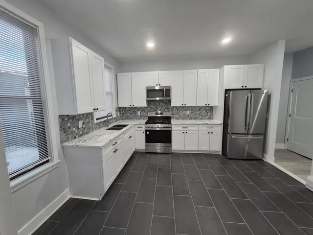 a view of room with wooden floor and fan